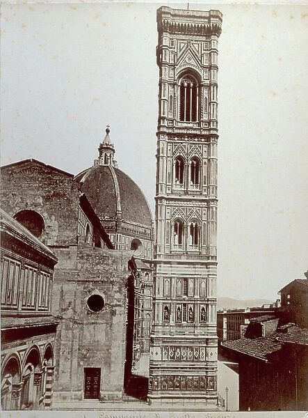 Giotto's Campanile in Florence. On the left partial view of the Baptistry and Arnolfo's facade of the Cathedral. In the background the Cathedral dome