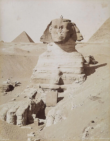 The Sphinx and, in the background, the Great Pyramid of Cheops. Cairo, El Giza