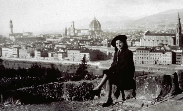 Young woman seated with the panorama of the city of Florence behind her