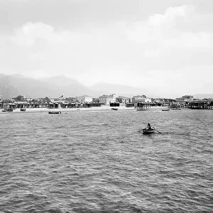 View of Forte dei Marmi and its beach seen from the loading bridge on the sea. In the background, the Apuan Alps are visible, Versilia
