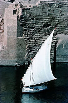 Images Dated 25th October 2011: assuan a felucca along the docks gigantic granite rocks of the island of Elephanta