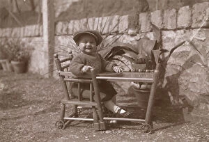 May Collection: Baby boy in a high-chair with wheels