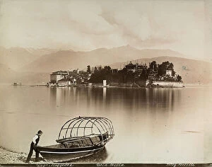 Images Dated 12th April 2011: Boat on the shore of Lake Maggiore in Stresa. In the background Isola Bella