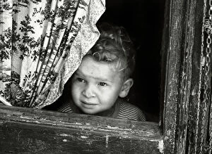 Images Dated 23rd May 2011: A boy watches from the window
