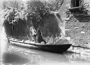 Images Dated 4th May 2010: A builder working on a canal in Venice