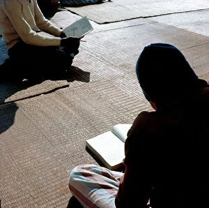 Images Dated 14th December 2011: Cairo. In the courtyard of a mosque in town, the Koranic school students leggoni sacred texts