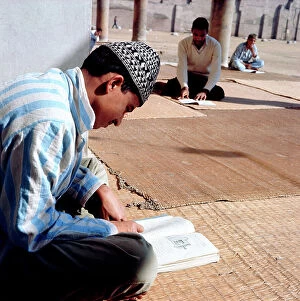 Images Dated 14th December 2011: Cairo. In the courtyard of a mosque in town, the Koranic school students leggoni sacred texts