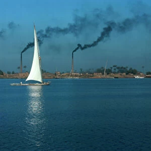 Images Dated 21st December 2011: Cairo. The Nile River on the outskirts of the city in the industrial area, with a boat