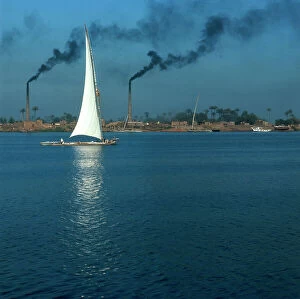 Images Dated 21st December 2011: Cairo. The Nile River on the outskirts of the city in the industrial area, with a boat