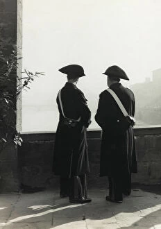 Florence Collection: Two Carabinieri staring over the river Arno, backwards portrait