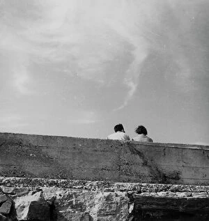 Images Dated 28th November 2011: Couple sitting behind a wall