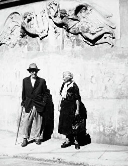 Images Dated 23rd November 2009: An elderly couple photographed in front of a wall decorated with a relief