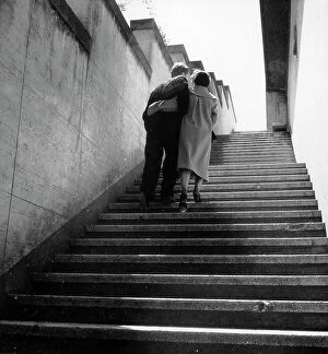 Images Dated 28th November 2011: Embracing couple climbs stairs