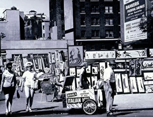 July Collection: Exposition of paintings on a street in New York. An ice cream salesman is in the foreground