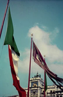 Images Dated 26th May 2011: Flags in the wind with the Clock Tower in the background, Piazza San Marco, Venice