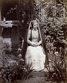 Images Dated 16th May 2011: Full-length portrait of Tatar (tartar) woman in traditional clothes. She is sitting in a garden