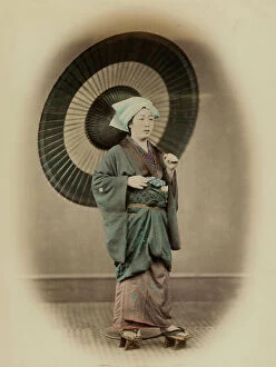 Images Dated 29th July 2011: Full-length portrait of a young japanese woman in traditional travel dress with high thonged clogs