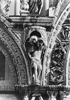 Images Dated 12th April 2010: Gargoyles, human figures that are holding up wineskins, west facade, Basilica of San Marco, Venice