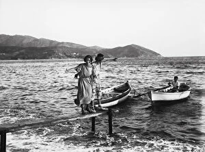 Images Dated 30th November 2009: Girls photographed on a boat mooring platform, Portoferraio, Elba Island