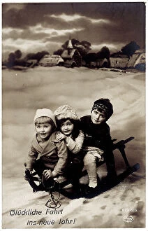Images Dated 19th September 2007: Group of children on a toboggan, New Year greetings postcard with inscription on the front