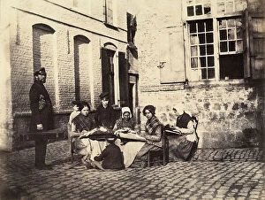 Images Dated 5th May 2011: A group of French women embroider while some children and a man look on
