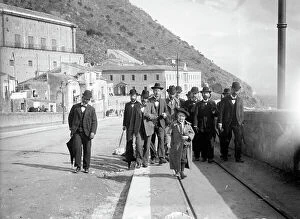 Images Dated 13th December 2012: A group of men with a child walk on the rails of the new tram line in Monreale