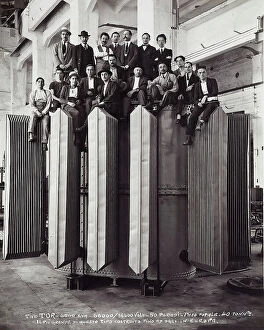 Images Dated 29th July 2009: Group of men seated on an enormous electric instrument
