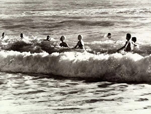 Images Dated 4th February 2011: Group of people playing in the waves of the sea