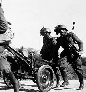 Images Dated 16th March 2009: Italian infantrymen photographed while they transport a military vehicle during World War II