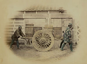 Japan: Japanese servants pulling a cart loaded with barrels