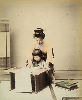 Japan: A Japanese teacher teaches a young pupil to write