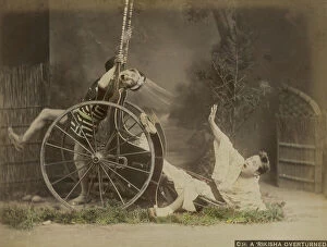 Japan: Two Japanese in traditional dress simulate falling from a rickshaw, Japan