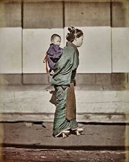 Japan: Japanese woman carrying her son on her shoulders