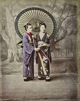 Japan: Two Japanese women in traditional clothes with a paper umbrella