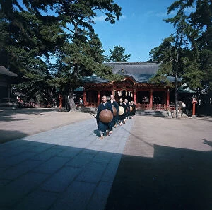 Japan: Kobe. Shofukuji Zen monastery. Monks exiting in the early morning to collect alms in the city