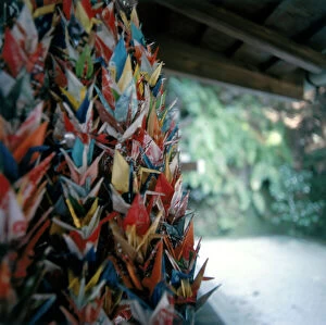 Images Dated 11th June 2009: Kyoto. Polychromed votive offerings of paper flowers, outside a Shinto temple