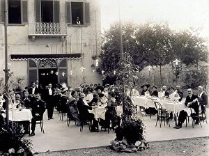 Images Dated 15th April 2011: A large group of people seated at table in the couryard of an open-air restaurant