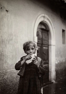 Images Dated 25th July 2011: A little girl having a snack in a courtyard
