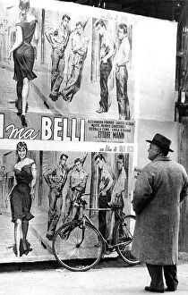 Images Dated 25th November 2011: Man looking at the poster of the film by the film-director Dino Risi Poveri ma belli