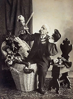 Images Dated 13th May 2011: Man seated on a wicker basket as he maneuvers some Bolognese puppets