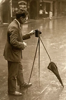 Images Dated 30th January 2007: Man takes a photo; the camera is mounted on a tripod with an umbrella leg
