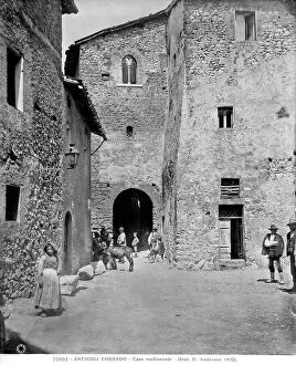Images Dated 24th April 2012: A Medieval house in Anticoli Corrado. In the foreground, a few passersby