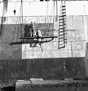Images Dated 4th May 2010: Men working on the hull of a ship