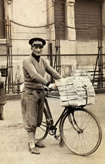 Images Dated 14th December 2009: Newspaper seller photographed at a cycling race