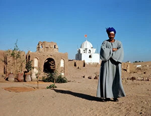 Images Dated 12th December 2011: Nubia. A man prays near the cemetery, on the border with Sudan