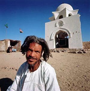 Images Dated 12th December 2011: Nubia. A man prays near the cemetery, on the border with Sudan