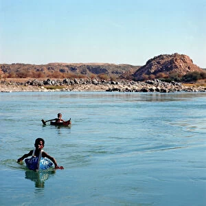 Images Dated 11th October 2011: Nubian kids on rudimentary boats with which they play and cross the river