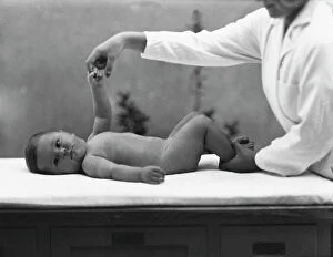 Images Dated 4th August 2009: Nurse with newborn during an exercise for the book 'La ginnastica del lattante' (Infant Exercises)