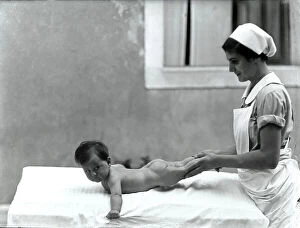 Images Dated 9th February 2009: Nurse with newborn during an exercise for the book 'La ginnastica del lattante' (Infant Exercises)