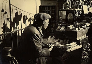 Images Dated 22nd March 2011: Old antique dealer with his merchandise. Postcard sent by the author to Vincenzo Balocchi